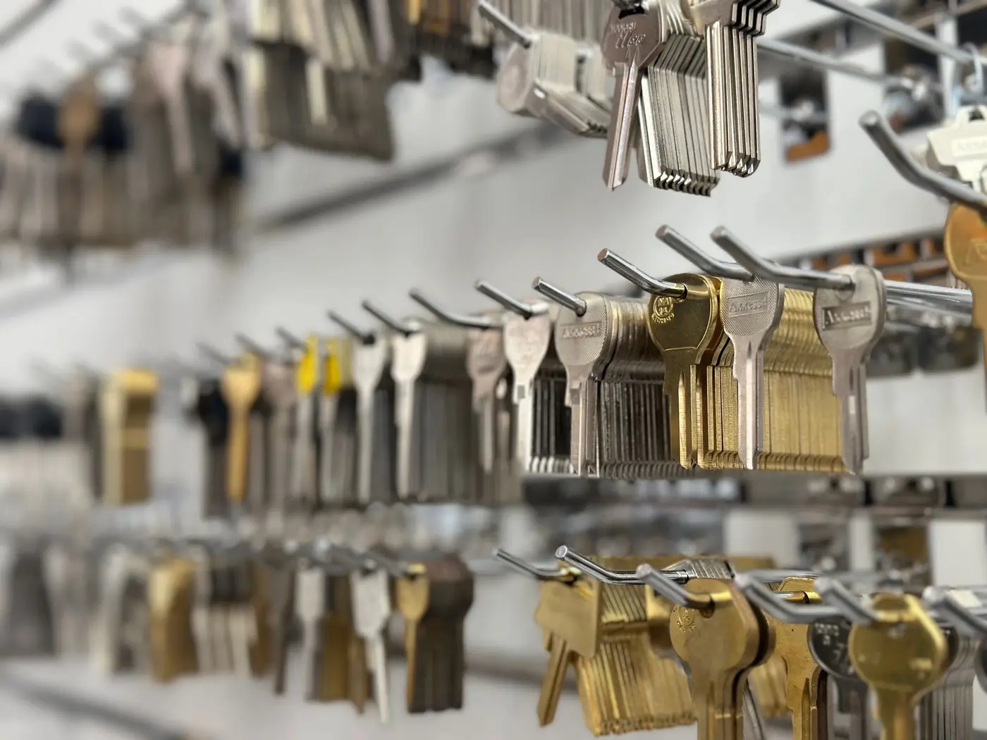 Rows of brass and silver key blanks on display hooks at the Locksmith Zone shop